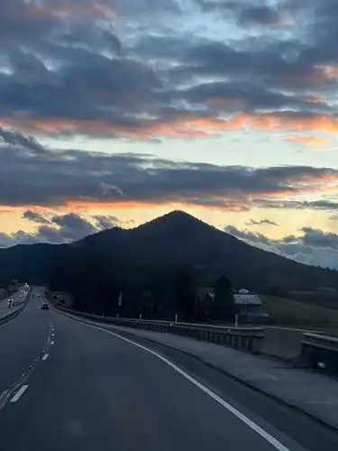 Sky on fire, mountains dark, the journey unfolds.